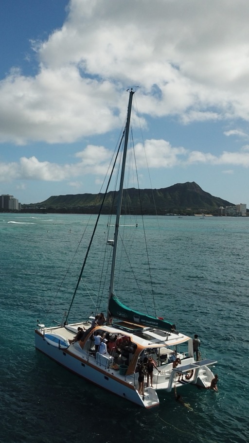 luxury sailing proposal on a catamaran off Waikiki with Diamond Head behind